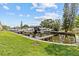 Manicured backyard with a canal view and dock at 800 Callista Cay Loop, Tarpon Springs, FL 34689