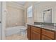 Bathroom featuring a tub, a window, a toilet and a sink vanity with stone countertops at 800 Callista Cay Loop, Tarpon Springs, FL 34689