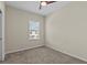 Neutral bedroom featuring plush carpet, a ceiling fan and bright natural light from the window at 800 Callista Cay Loop, Tarpon Springs, FL 34689