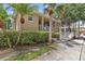 Clubhouse with walkway, bushes and shade trees at 800 Callista Cay Loop, Tarpon Springs, FL 34689