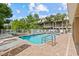 Sparkling community pool surrounded by lounge chairs and lush palm trees at 800 Callista Cay Loop, Tarpon Springs, FL 34689