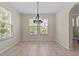 A bright dining room featuring tiled floors, modern lighting and large windows at 800 Callista Cay Loop, Tarpon Springs, FL 34689
