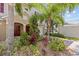 Townhouse with meticulously maintained landscaping, front lawn and paved driveway at 800 Callista Cay Loop, Tarpon Springs, FL 34689