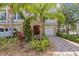 Inviting townhouse with meticulous landscaping, front lawn and paver driveway at 800 Callista Cay Loop, Tarpon Springs, FL 34689