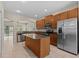 This kitchen features stainless steel appliances, granite countertops, and a large island at 800 Callista Cay Loop, Tarpon Springs, FL 34689