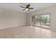 Spacious living room featuring tile floors, ceiling fan and sliding doors to the outdoor patio at 800 Callista Cay Loop, Tarpon Springs, FL 34689