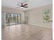Spacious living room featuring tile floors, ceiling fan and sliding doors to the outdoor patio at 800 Callista Cay Loop, Tarpon Springs, FL 34689