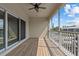 The patio has wood floors, a ceiling fan, and screens at 800 Callista Cay Loop, Tarpon Springs, FL 34689