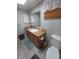 Bathroom featuring a wood vanity, large mirror, and tile flooring; toilet is also visible at 8313 Cavalry Dr, Hudson, FL 34667