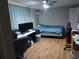 Bedroom with laminate flooring, a ceiling fan, and a large window for natural light at 8313 Cavalry Dr, Hudson, FL 34667
