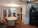Dining room with a chandelier, table, and chairs, leading to a set of French doors at 8313 Cavalry Dr, Hudson, FL 34667
