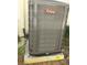 Close-up of an AirTemp branded HVAC unit with hurricane strap at 8313 Cavalry Dr, Hudson, FL 34667