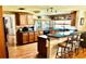 Traditional style kitchen featuring wood cabinets, a peninsula with bar seating, and a window over the sink at 8313 Cavalry Dr, Hudson, FL 34667