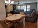 Spacious living room with wood floors, comfortable seating, and natural light from large windows at 8313 Cavalry Dr, Hudson, FL 34667