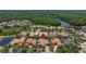 Aerial view of a residential area showcasing a home with a pool and surrounding lush landscapes at 8434 Dunham Station Dr, Tampa, FL 33647