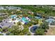 Gorgeous aerial view showcasing the community pool, tennis courts, and playground amidst lush landscaping at 8434 Dunham Station Dr, Tampa, FL 33647