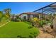 Beautiful backyard with artificial grass, a tiled roof home, and a cozy lounge area, perfect for relaxation at 8434 Dunham Station Dr, Tampa, FL 33647
