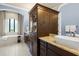 Bright bathroom features a large vanity, soaking tub, and arched window at 8434 Dunham Station Dr, Tampa, FL 33647