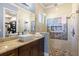 Bathroom boasts granite countertops, dual vanity, and a tiled walk-in shower at 8434 Dunham Station Dr, Tampa, FL 33647