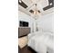 Bedroom boasts a decorative ceiling, chandelier, television, and bright natural light at 8434 Dunham Station Dr, Tampa, FL 33647