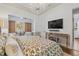 Spacious bedroom with TV, lounge area, and decorative lighting at 8434 Dunham Station Dr, Tampa, FL 33647