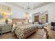Bedroom with an ornate chandelier, dark wood floors, and patterned bedding at 8434 Dunham Station Dr, Tampa, FL 33647