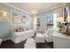 Cozy bedroom featuring a daybed, elegant chandelier, and ample natural light at 8434 Dunham Station Dr, Tampa, FL 33647