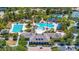 Aerial view of the community clubhouse, lap pool and Gathering pool with palm trees and shaded seating areas at 8434 Dunham Station Dr, Tampa, FL 33647