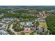 Expansive aerial view of the community showcasing the clubhouse, pools, tennis courts and lush landscape at 8434 Dunham Station Dr, Tampa, FL 33647