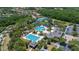 Aerial view showcases the community pool with a variety of amenities, including tennis courts and a clubhouse at 8434 Dunham Station Dr, Tampa, FL 33647
