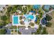 Aerial view of the community pool area, complete with a lap pool, lounge chairs, and lush landscaping at 8434 Dunham Station Dr, Tampa, FL 33647