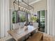Spacious dining area with rustic wood table and view of the outdoor pool and entertaining area at 8434 Dunham Station Dr, Tampa, FL 33647