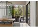 Dining room with rustic table and large glass doors that open to outdoor dining and pool area at 8434 Dunham Station Dr, Tampa, FL 33647