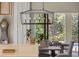 Bright dining area features modern chandelier and natural light overlooking lush greenery at 8434 Dunham Station Dr, Tampa, FL 33647