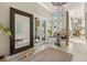 Inviting foyer featuring a large mirror, decorative rug, and stylish decor at 8434 Dunham Station Dr, Tampa, FL 33647