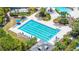 Aerial view of the freeform Gathering pool featuring a water slide, sun loungers, and shady cabanas at 8434 Dunham Station Dr, Tampa, FL 33647
