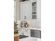 Bright kitchen with white cabinets, a modern backsplash, stainless steel appliances, and quartz countertops at 8434 Dunham Station Dr, Tampa, FL 33647