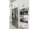 Close-up of stainless steel refrigerator, microwave, and oven with white cabinets at 8434 Dunham Station Dr, Tampa, FL 33647