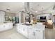 A modern kitchen is centered around a large island with stainless steel appliances and flows to the Gathering room at 8434 Dunham Station Dr, Tampa, FL 33647