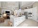 A modern kitchen with stainless steel appliances and white cabinetry flows to a living room with a fireplace at 8434 Dunham Station Dr, Tampa, FL 33647