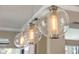Stylish glass pendant lighting fixture adds a touch of elegance to the kitchen or dining area at 8434 Dunham Station Dr, Tampa, FL 33647