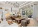 A comfortable living room is furnished with a leather sofa, chairs, ottomans, an area rug, and an oversized sliding glass door at 8434 Dunham Station Dr, Tampa, FL 33647