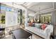 Open-concept living room featuring a white sofa, modern lighting, and access to outdoor spaces at 8434 Dunham Station Dr, Tampa, FL 33647