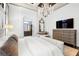 Spacious main bedroom with tray ceiling, decorative chandelier, and ensuite bathroom at 8434 Dunham Station Dr, Tampa, FL 33647
