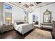 Spacious main bedroom with tray ceiling, decorative chandelier, and ensuite bathroom at 8434 Dunham Station Dr, Tampa, FL 33647