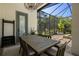 Charming outdoor dining area with a wooden table and seating for six, perfect for alfresco meals at 8434 Dunham Station Dr, Tampa, FL 33647