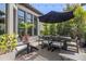 Outdoor patio area with string lights, a dining table, and lush greenery at 8434 Dunham Station Dr, Tampa, FL 33647