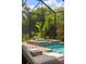 Inviting pool area with a spa, lounge chairs, and tropical plants, perfect for relaxation and entertainment at 8434 Dunham Station Dr, Tampa, FL 33647