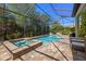 Screened-in pool and spa with brick paver surround and lush landscaping at 8434 Dunham Station Dr, Tampa, FL 33647