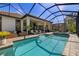 Screened-in pool and spa area with covered patio and seating at 8434 Dunham Station Dr, Tampa, FL 33647
